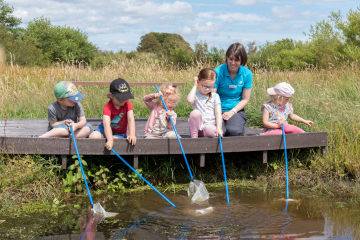 Engagement Officer Faith Hillier pond dipping with a group young visitors at WWT Caerlaverock.jpg